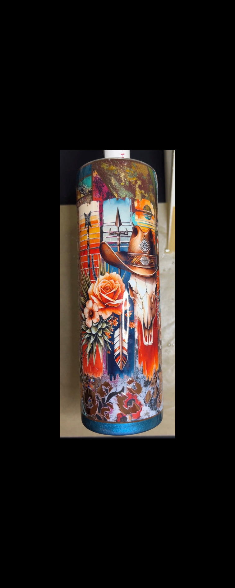 Colorful Tumbler  with Native American design featuring a skull, feathers, and floral elements.