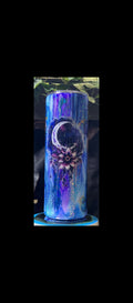 Tumbler with a floral design and moon symbol on a blue gradient background